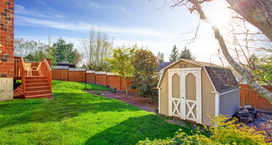 Fenced backyard with storage shed in Lima